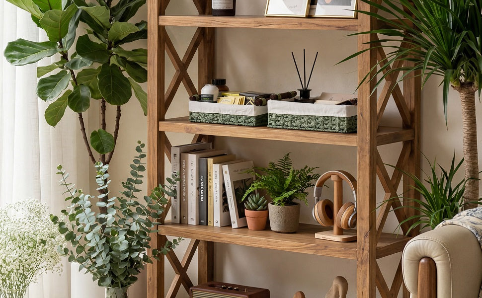 Two green paper rope storage baskets with fabric lining on the top shelf of a wooden bookcase in a plant-filled living room