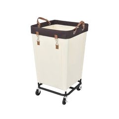 Large rolling laundry basket with wheels, beige fabric, black metal frame, brown handles, removable liner.