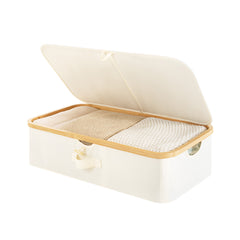 Underbed storage box with bamboo frame, beige fabric, flip-top lid, and fabric handles, fully filled.
