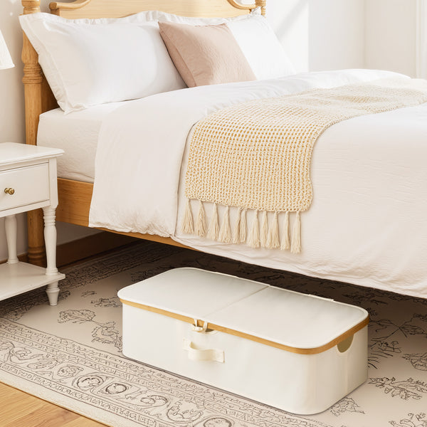 Underbed storage box with bamboo frame, beige fabric, rectangular design, placed under a bed in a bedroom setting.